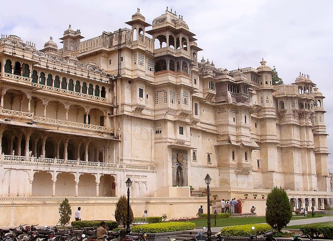 The carved balconies and white facade of City Palace in Udaipur